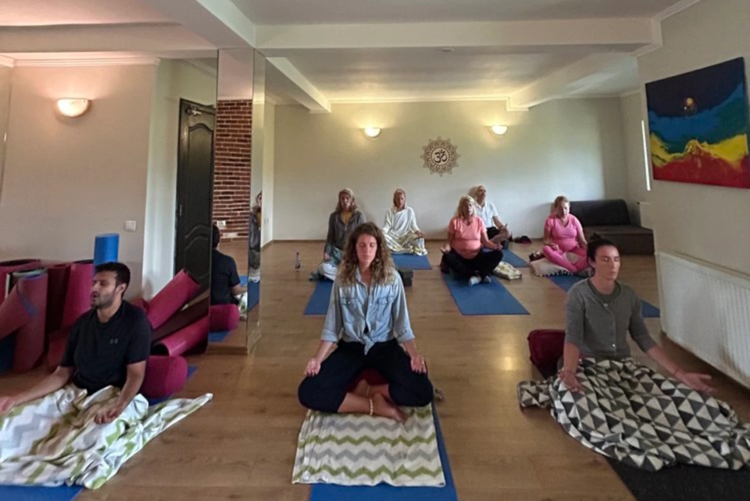 Yoga — instructor guiding in studio